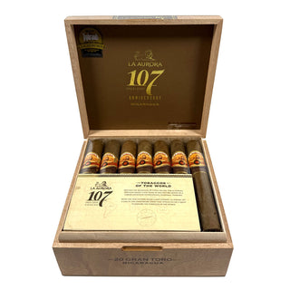 Open wooden box of La Aurora 107 Nicaragua cigars on a white background.