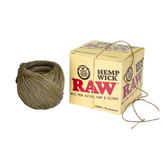 Ball of RAW hemp wick next to its packaging on a white background