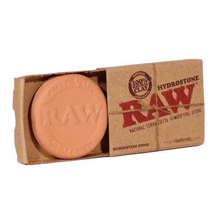 Raw natural terra cotta humidifying stone in a cardboard packaging on a white background