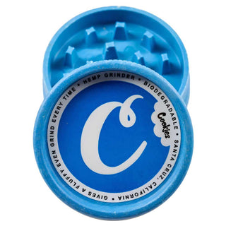 Blue herb grinder with 'Cookies' branding on a white background
