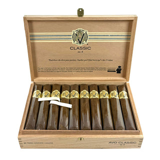 Open wooden box of AVO Classic cigars with cigars inside on a white background