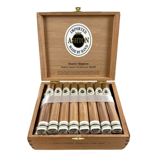 Open wooden box of Ashton cigars with cigars inside on a white background