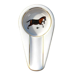 Decorative spoon shaped cigar ashtray with a horse design on a white background