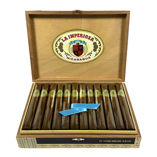 Open wooden box of Crowned Head La Imperiosa cigars with cigars inside on a white background