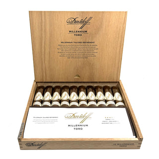 Open wooden cigar box of Davidoff Millennium Toro cigars on a white background