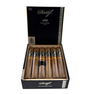 Open box of Davidoff Nicaragua Toro cigars with cigars visible inside on a white background
