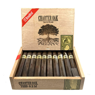 Open wooden box of Foundation Charter Oak CT Broadleaf Toro cigars with cigars inside on a white background