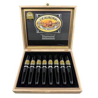 Open wooden cigar box with La Aurora cigars inside on a white background