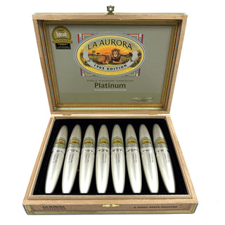 Open wooden cigar box displaying La Aurora Preferido Platinum cigars on a white background