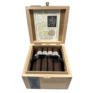 Open wooden cigar box with Liga Privada No 9 cigars and visible branding on a white background