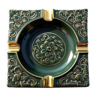 Decorative green and gold ashtray with intricate patterns on a white background