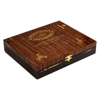 Wooden Montecristo 1935 Anniversary Nicaragua cigar box with gold embossed text on a white background