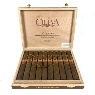 Open wooden box of Oliva Serie V Melanio cigars on a white background