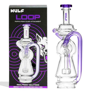 Clear Puffco Peak glass smoking attachment with purple accents next to its packaging box.